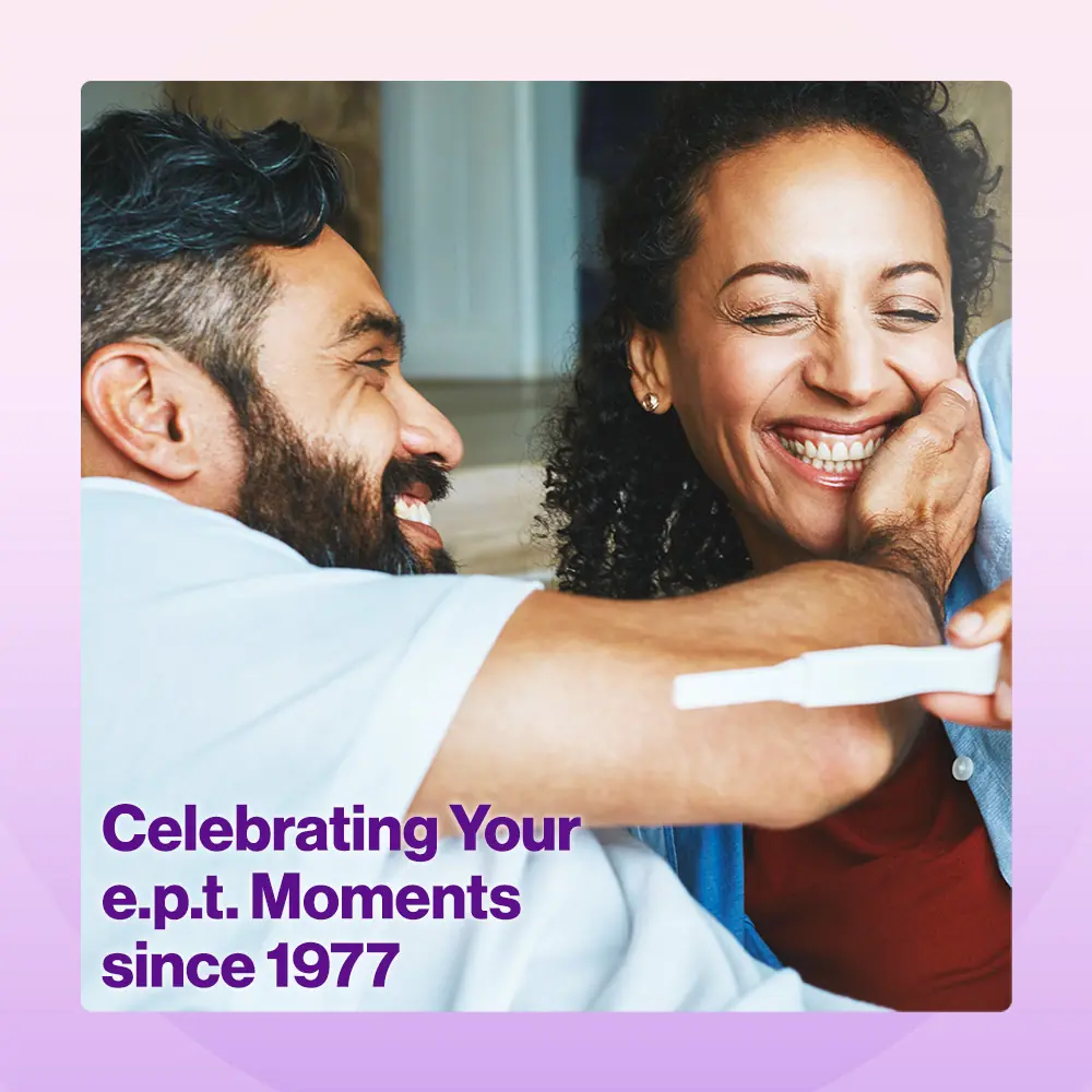 A happy couple looks at a positive pregnancy test with the words - Celebrating your e.p.t. moments since 1977.